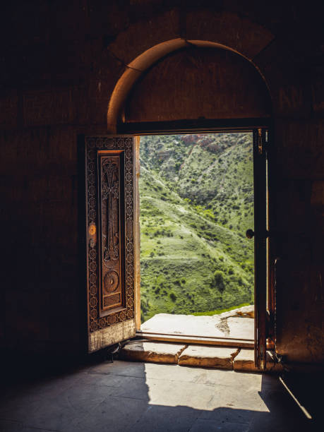 istock view through church doors on green hill 1001534062