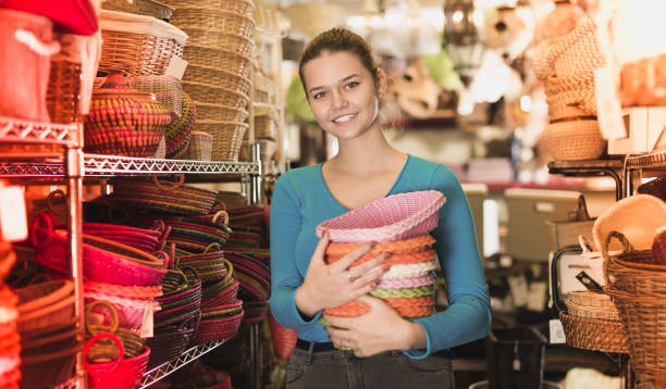 istock Girl standing with pile of different wicker basket 1001534484