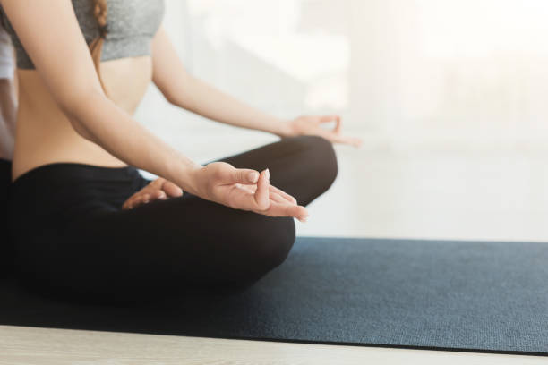 istock Young woman sitting in lotus pose 1001549290
