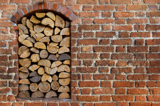 Brick, old wall with a niche in which wood is placed into the fireplace