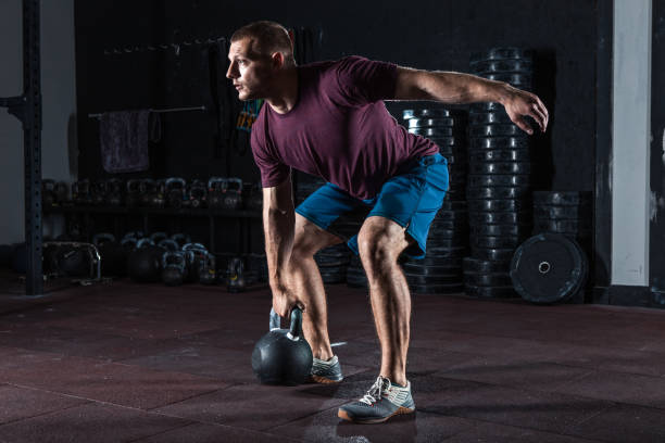 young muscular man training with kettlebells. - secrecy instructor exercising individuality imagens e fotografias de stock