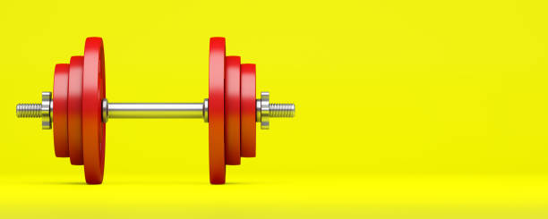 istock red dumbbell isolated on yellow background 1001563174