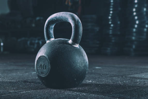 Kettlebell training in gym Kettlebell training in gym kettlebell stock pictures, royalty-free photos & images
