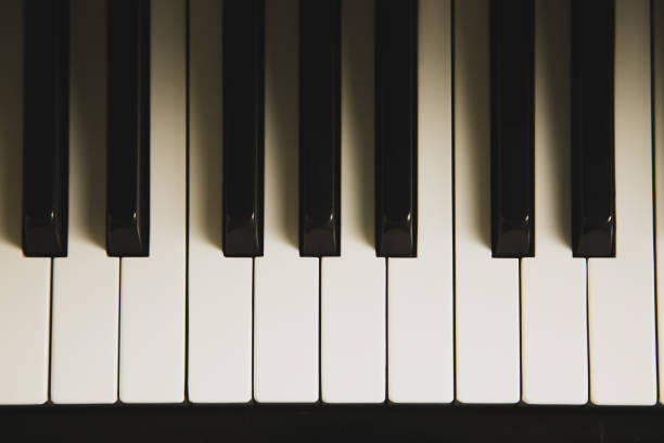 Top view of the piano keyboard with lighting and shadow. stock photo