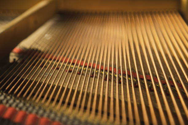 The inside of a classical  grand piano instrument with copper cord strings. stock photo