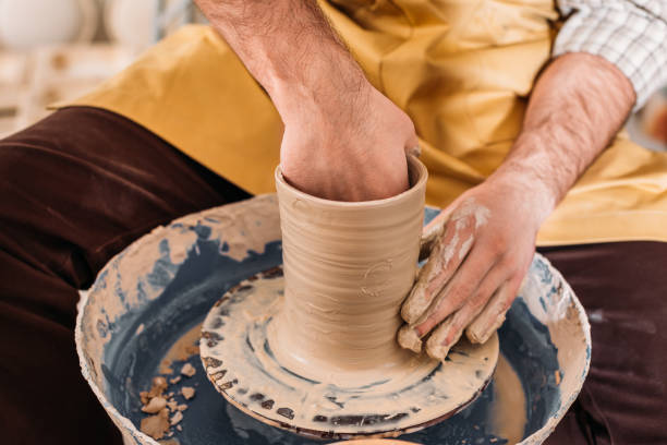 istock cropped view of potter making ceramic pot on pottery wheel 1001566132