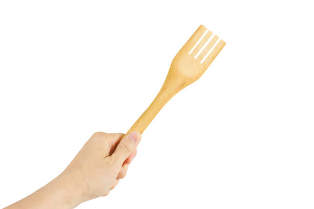 istock Fork wood handmade in hand isolated on white background. 1001566732