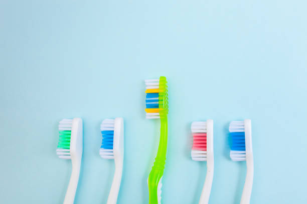 istock Toothbrushes on light blue background, close up different kinds of Toothbrushes, new not used, isolated for text insertion 1001566998