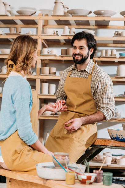istock happy couple in aprons with ceramics 1001568284