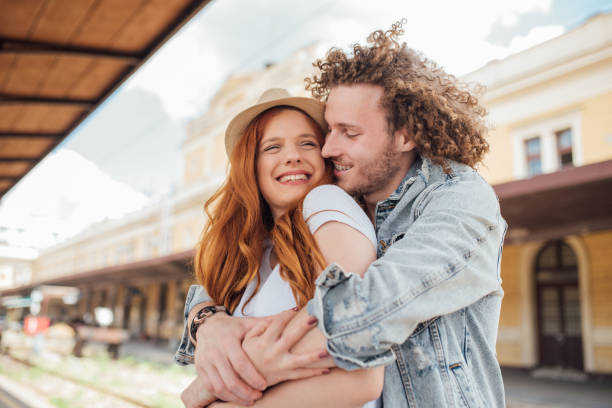 istock Young couple cuddling and hugging at the railway station 1001568688