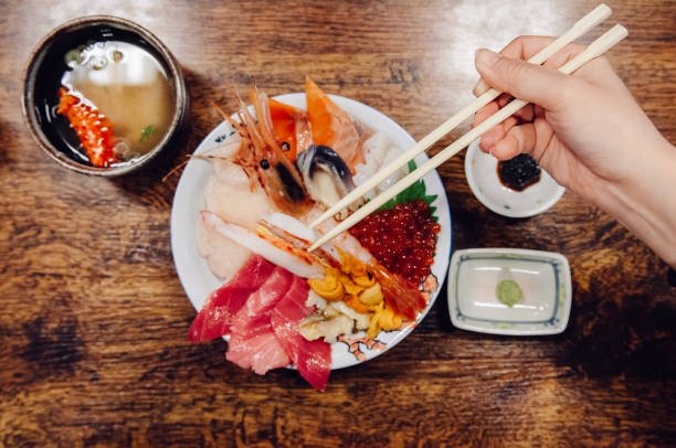 istock Kaisendon Japanese sashimi rice bowl on wood table top view shot 1001571044