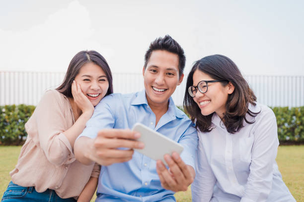 istock Asian friends having fun while smartphone 1001572104