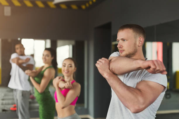 istock Fitness group warmup stretching training indoors 1001576330