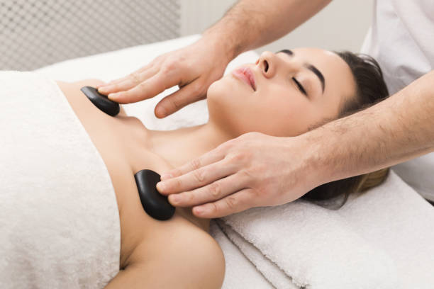 istock Woman getting hot stones massage at spa salon 1001583780