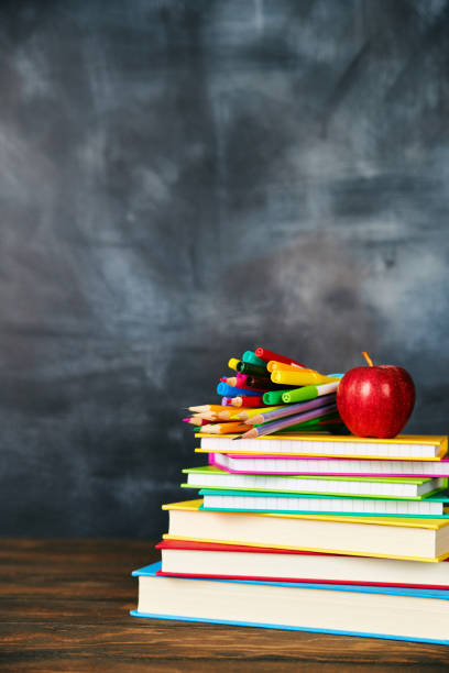 istock Back to school supplies against weathered chalkboard 1001583852