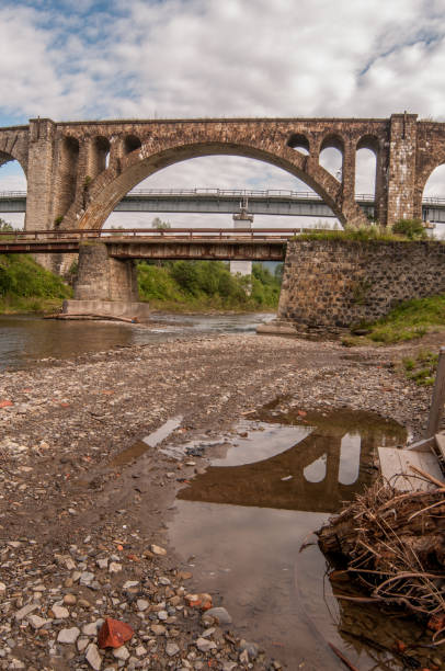 istock Carpathian stone aqueduct reflected in water 1001583958