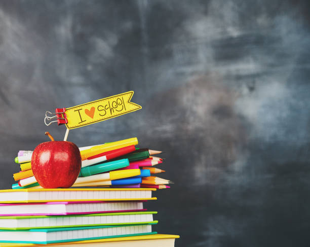 istock Colorful pencils and pens against weathered chalkboard 1001584088
