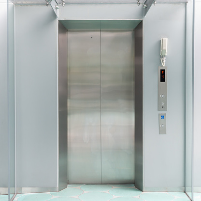 Front view of modern elevator with closed doors.