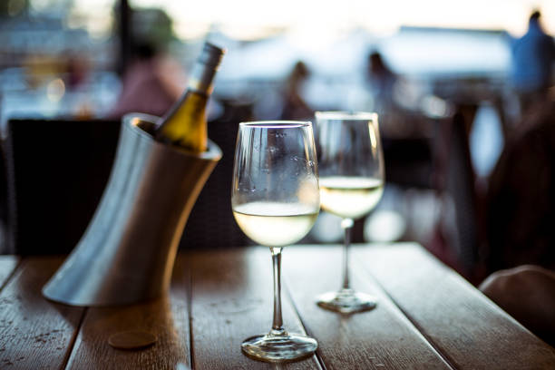 istock Two glasses of white wine on a restaurant table 1001592756