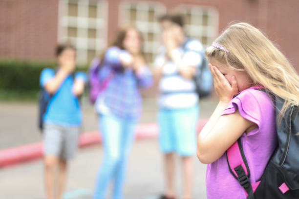 istock Elementary age girl being bullied at school. 1001597238