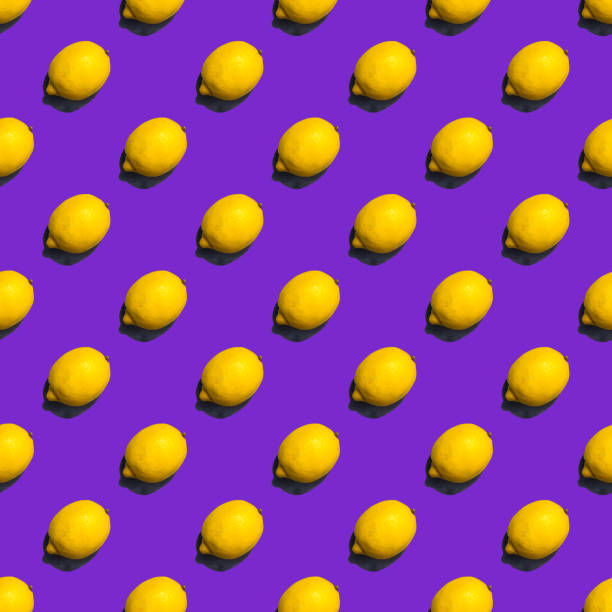 istock Seamless pattern of lemons on violet background; flat lay 1001597240
