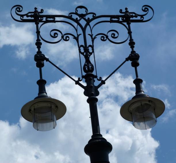 istock Retro style street lights under blue sky with clouds 1001603264