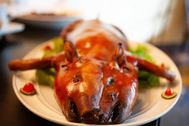 Photo of Delicious, Golden Roasted BBQ Suckling pig Cantonese Style made from a piglet.