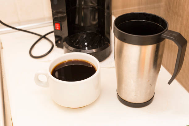 istock image of american coffeepot with white cup and spilled coffee 1001603802
