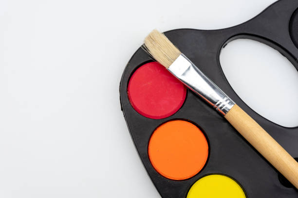 istock paintbrushes palette and watercolor paints 1001604234