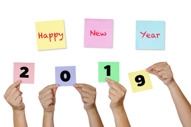 istock Woman hand hold Paper notes with label Happy New Year 2019 (New year coming concept) 1001604246