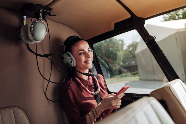 istock Cheerful jolly woman texting in helicopter 1001604286