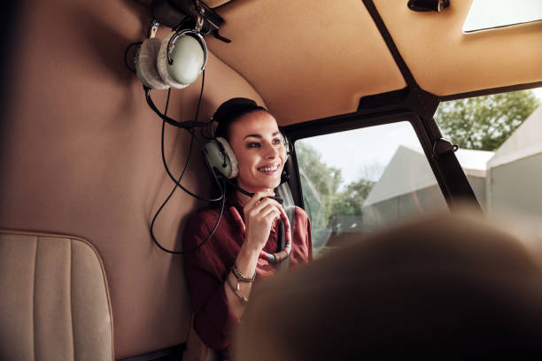 istock Optimistic young woman taking seat in helicopter 1001604534
