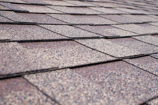 istock Close up view on asphalt roofing shingles. 1001604706