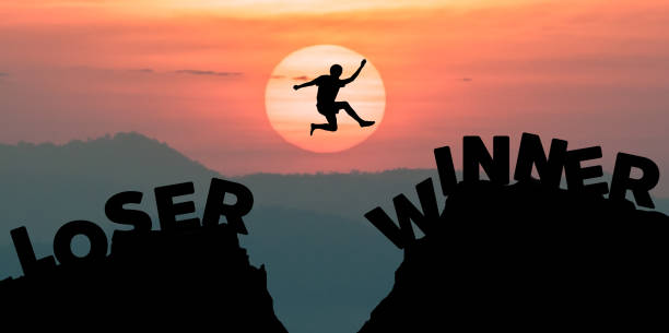 istock Man jumping over precipice between two rocky mountains at sunset. Freedom, risk, challenge, success. 1001607042