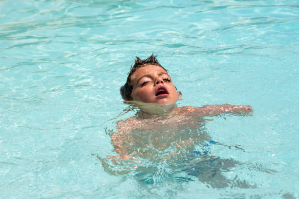 Child drowns in out door swimming pool Child drowns in out door swimming pool while swimming alone, asking for help. drowning photos stock pictures, royalty-free photos & images