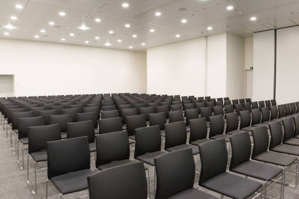 istock Conference and Meeting Room with Rows of Black Chairs 1001610842