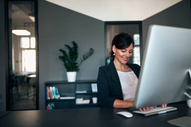 istock Female entrepreneur working while sitting at a desk typing on the computer keyboard. 1001611280