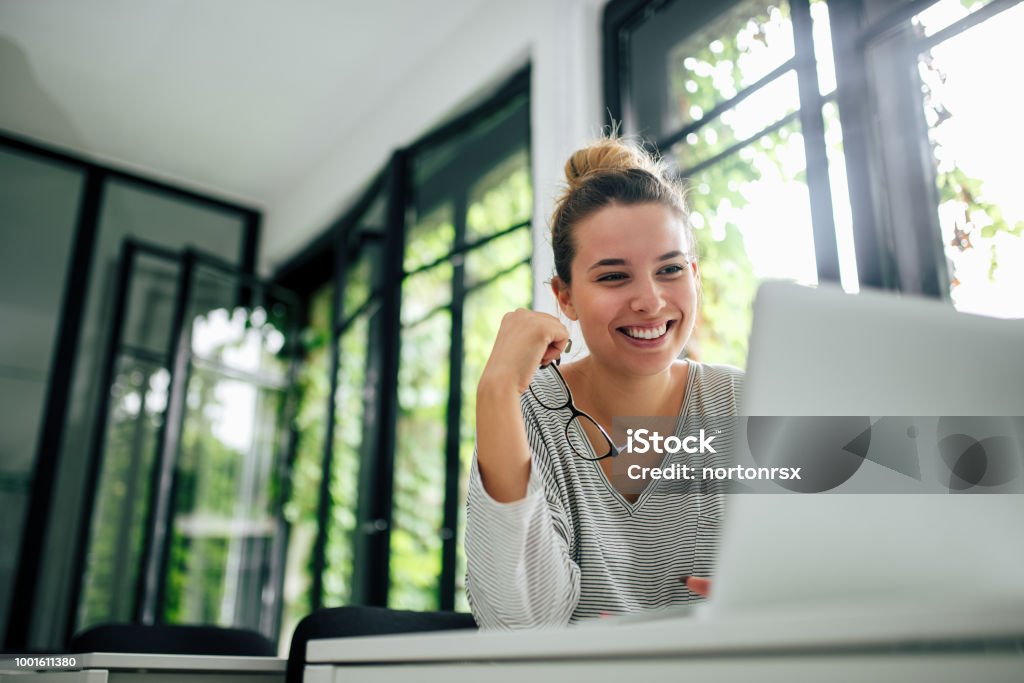 Beautiful smiling girl using laptop. Close-up. Laptop Stock Photo