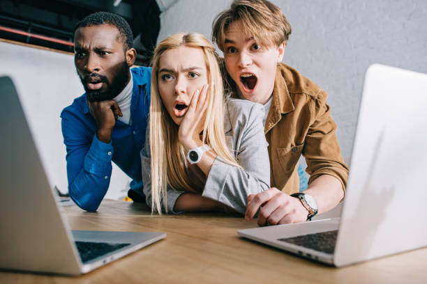 istock shocked multicultural business colleagues watching on laptop screen 1001615128