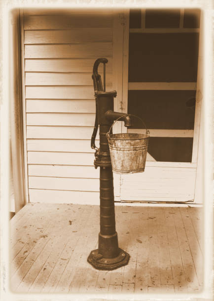 Water pump in front of weathered screen door