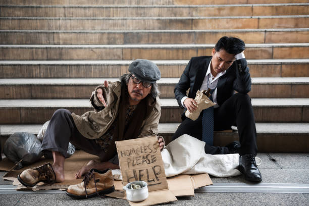 istock Beggar old man and drunk Businessman in town 1001618938