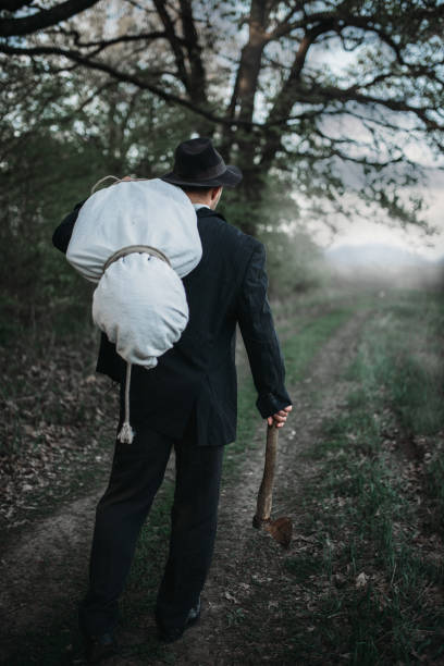 istock Slayer with an axe carries the victim's body 1001625314