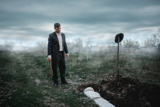 Maniac against grave with victim, crime horror