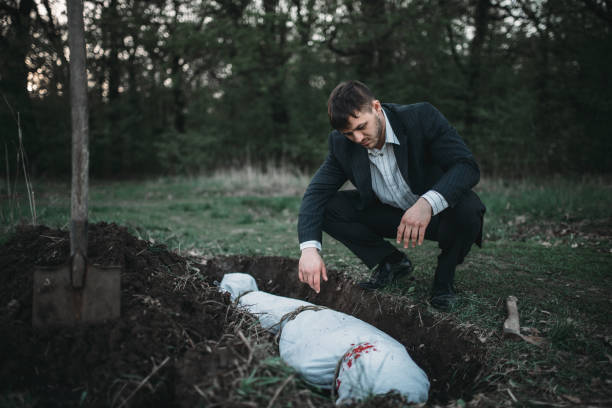 istock Maniac against grave, serial murderer concept 1001625736