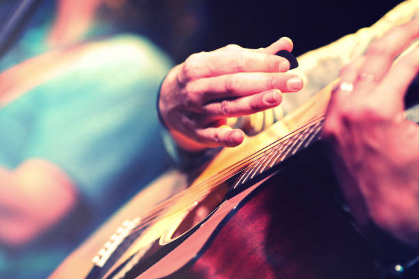 istock Playing acoustic guitar, close up on the hand 1001631364