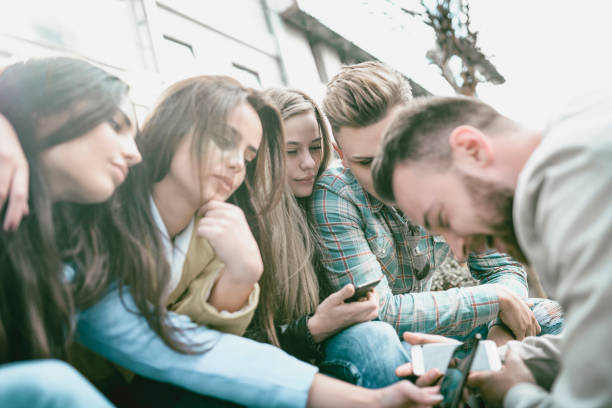 istock Group Of Friends Taking Selfies And Reading Funny Blogs On Internet 1001634734
