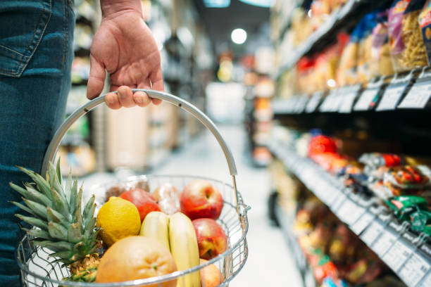 istock Male customer hand with basket, supermarket 1001639266