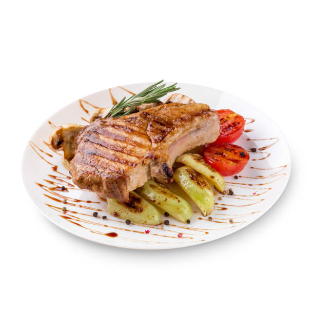 istock Plate of grilled steak meat with vegetables on white background 1001650466