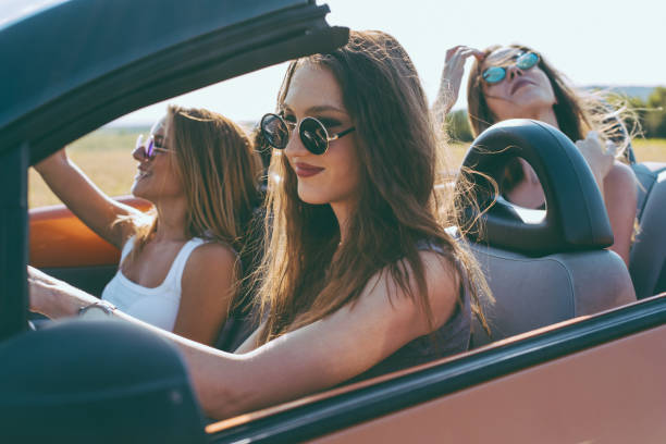 istock Young women on a road trip with cabriolet 1001652994