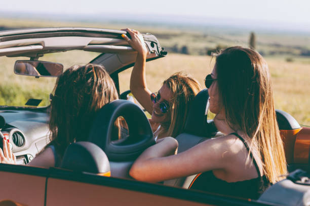 istock Young women on a road trip with cabriolet 1001653222